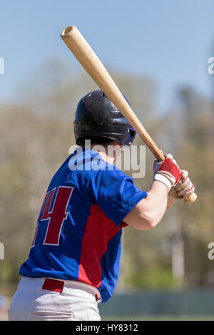 Baseball player holding baseball bat. Stock Photo