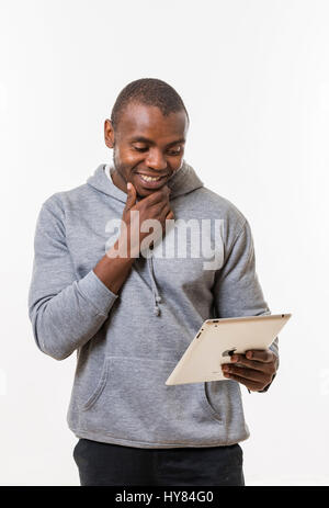 An African man uses a tablet in a studio environment. Stock Photo