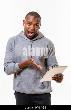 An African man uses a tablet in a studio environment. Stock Photo