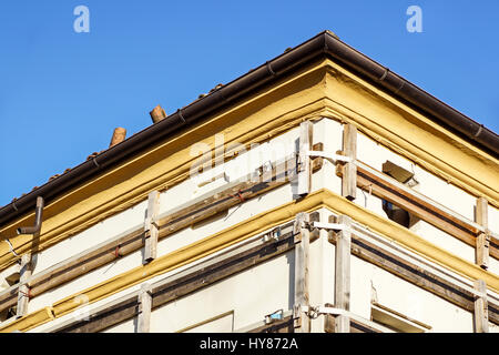 Facade of an old italian masonry building with metal tie-rod, containment straps and anchor plate. Stock Photo