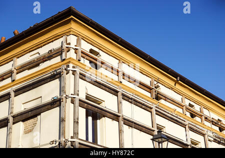 Facade of an old italian masonry building with metal tie-rod, containment straps and anchor plate. Stock Photo