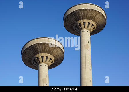 concrete two water towers against blue sky Stock Photo