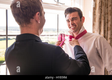 A groom and best man prepare for a wedding Stock Photo