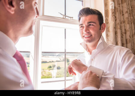 A groom and best man prepare for a wedding Stock Photo