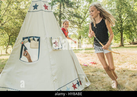 Young children play games outside in the sunshine Stock Photo