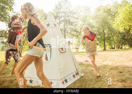 Young children play games outside in the sunshine Stock Photo