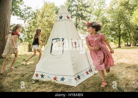 Young children play games outside in the sunshine Stock Photo