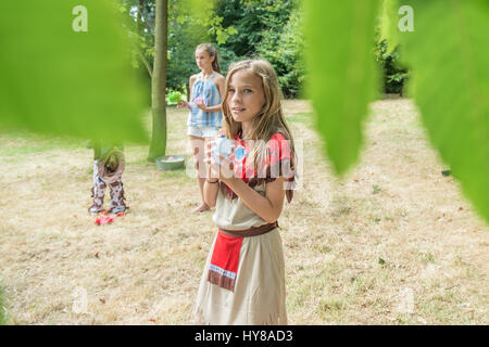 Young children play games outside in the sunshine Stock Photo