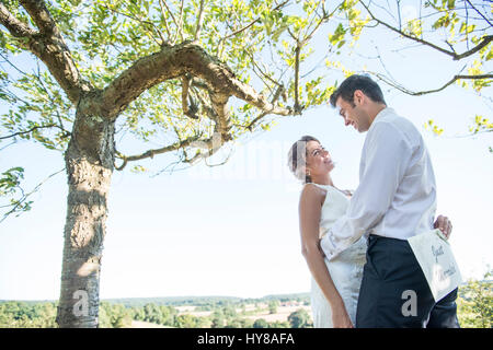 A bride and groom enjoying their wedding day in the sunshine Stock Photo