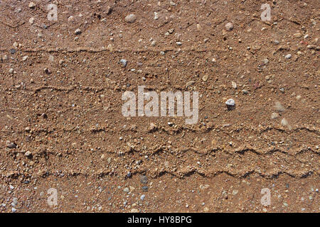 Gravel road surface with a print of a plurality of wheels. Stock Photo