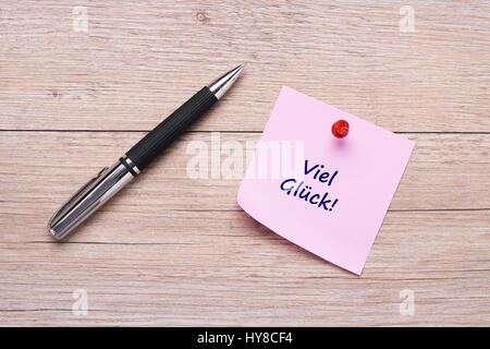 German concept word "Viel Glück" on pink sticky note with red pin Stock Photo