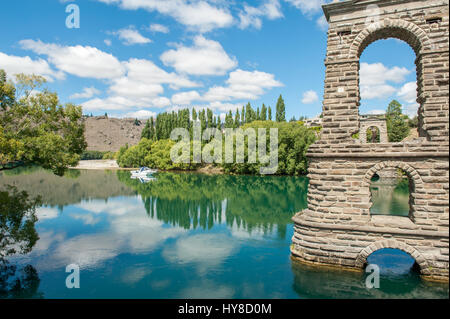 Clutha river and the old Alexandra Bridge piers in Alexandra. Alexandra is a historic gold mining town in Central Otago, New Zealand. Stock Photo