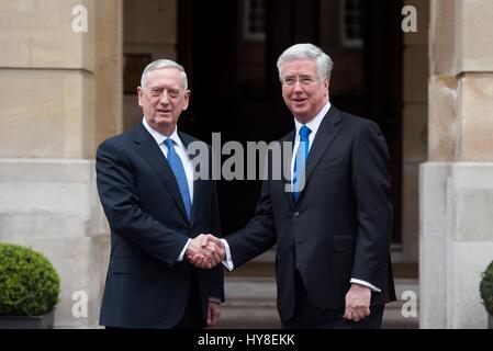 U.S. Secretary of Defense Jim Mattis is welcomed by British Defence Minister Sir Michael Fallon, left, prior to their meetings at Whitehall March 31, 2017 in London, United Kingdom. Stock Photo