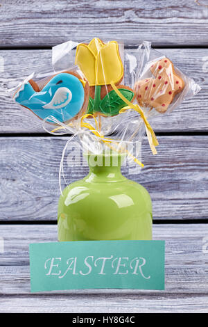 Vase with biscuits, Easter card. Glazed cookies wrapped in plastic. Stock Photo