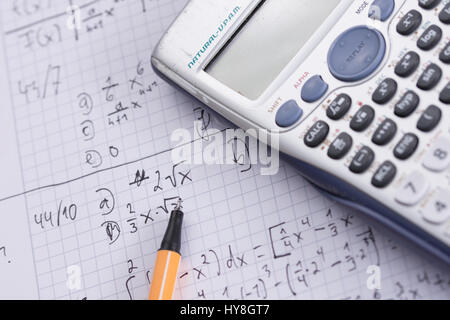 Close up photo of a calculator on an exercise book next to a pen Stock Photo