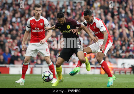 Arsenal's Theo Walcott (right) scores his side's first goal of the game during the Premier League match at the Emirates Stadium, London. Stock Photo