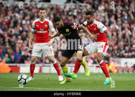 Arsenal's Theo Walcott (right) scores his side's first goal of the game during the Premier League match at the Emirates Stadium, London. Stock Photo