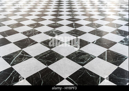 Black and white checkered marble floor with sunlight Stock Photo