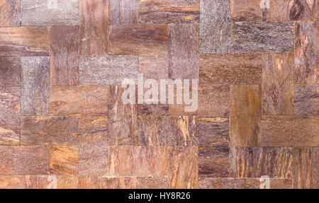 A wall of stone tiles or brick, classic example of exterior wall decoration or background Stock Photo