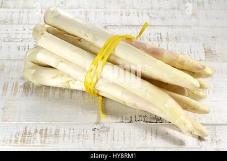 bundle of white asparagus on wooden background Stock Photo