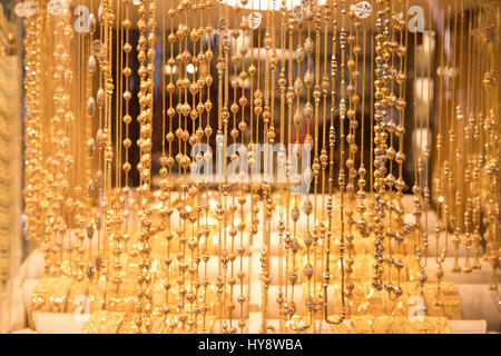 Gold jewelry on window display in Dubai gold souk. Stock Photo