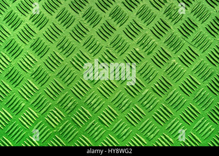 Green metal surface background with repeating diamond pattern, old used painted industrial metallic plate texture Stock Photo