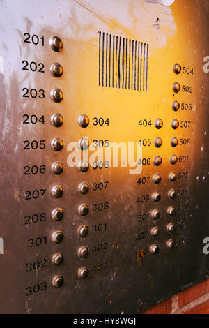 Old weathered intercom button panel, selective focus Stock Photo
