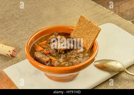 Meat and vegetable stew in earthenware bowl Stock Photo