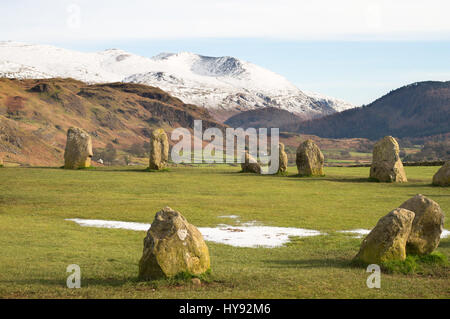 A snow capped Helvellyn seen from Castlerigg Stone Circle near Keswick, Cumbria, England, UK Stock Photo