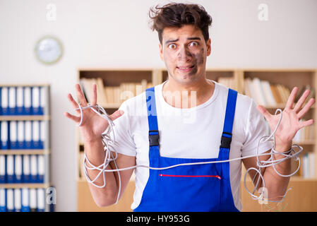 Funny Man doing electrical repairs at home Stock Photo