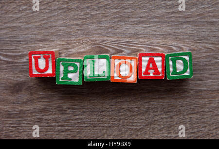 Wood Block letters forming the word UPLOAD Stock Photo