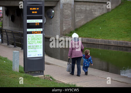 greener scotland #activetravel passing pedestrians  granny and grandchild on the forth clyde canal cycle path Stock Photo