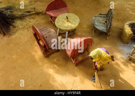 Young lady sweeping in the early morning light with copy space Stock Photo