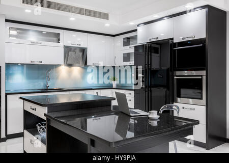 Black and white, stylish, high gloss kitchen with island Stock Photo