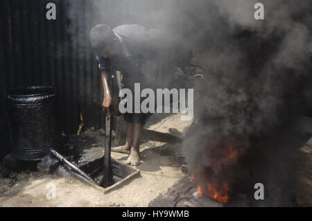 April 2, 2017 - Dhaka, Bangladesh - A child labor Yeachin (13), works in smoke at Keraniganj dockyard. (Credit Image: © Md. Mehedi Hasan via ZUMA Wire) Stock Photo