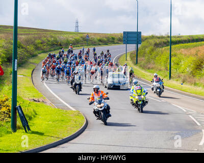 Cleveland England UK April 2nd 2017: The Cleveland Klondike Grad Prix cycle race for professional riders took place today. With start and finish in Guisborough Cleveland the 92 mile 149km race took place over four laps of a circuit through the East Cleveland villages, coast and countryside. 140 riders took part and the race was won by Chris Latham of Team Wiggins (3:59.16), ahead of Enrique Sanz (Raleigh GAC) and third place BIKE Channel Canyon rider Harry Tanfield, a local rider from Great Ayton. Riders descending into Carlin How on the first lap Credit: Peter Jordan NE/Alamy Live News Stock Photo