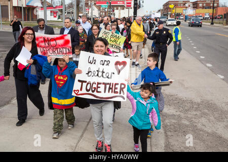 Detroit and Dearborn, Michigan, USA. 2nd Apr, 2017. 'Neighbors Building Bridges': Mexican and Muslim immigrants march from St. Gabriel's Catholic Church to the American Muslim Society's mosque to show unity and to oppose President Trump's plans to build a border wall and to stop Muslim travel to the United States. Credit: Jim West/Alamy Live News Stock Photo