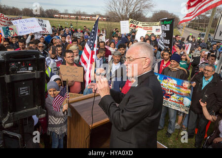 Detroit and Dearborn, Michigan, USA. 2nd Apr, 2017. 'Neighbors Building Bridges': Mexican and Muslim immigrants march from St. Gabriel's Catholic Church to the American Muslim Society's mosque to show unity and to oppose President Trump's plans to build a border wall and to stop Muslim travel to the United States. Catholic Bishop Donald Hanchon addressed the crowd at a rally outside the mosque. Credit: Jim West/Alamy Live News Stock Photo