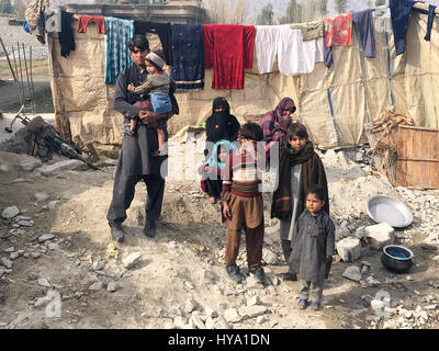 Nangarhar, Afghanistan. 22nd Jan, 2017. Afghan refugees that returned from Pakistan stand in a small area they fenced off with canvas covers and stones in the province of Nangarhar, Afghanistan, 22 January 2017. Photo: Christine-Felice Röhrs/dpa/Alamy Live News Stock Photo
