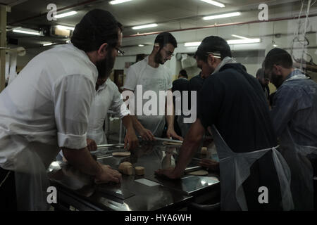 Kfar Chabad, Israel. 3rd April, 2017. Men prepare hand made matzah in the Chabad Matzah Bakery in the village of Kfar Chabad. Credit: Nir Alon/Alamy Live News Stock Photo