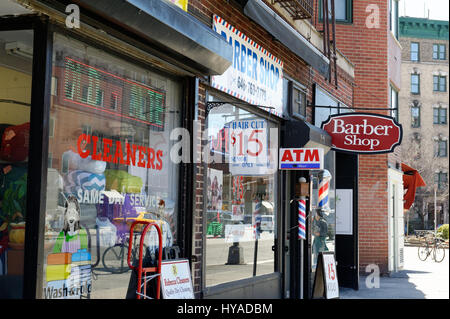 A dry cleaners and an old-fashioned barber shop are among the stores on Seventh Avenue in Greenwich Village, Manhattan. March 29, 2017 Stock Photo