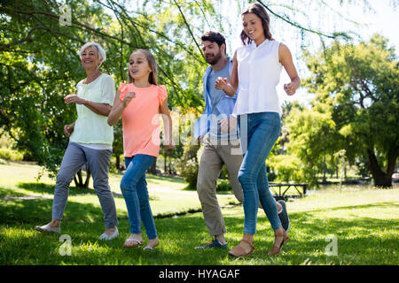 Multi generation family running in park on a sunny day Stock Photo
