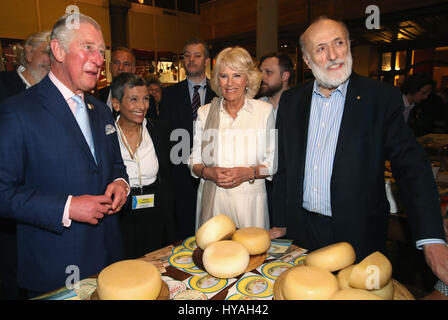 The Prince of Wales and the Duchess of Cornwall with the founder Carlo Petrini (right) as they visit Sant'Ambrogio Market to celebrate the Slow Food movement and meet local food producers of the Abruzzo region and areas affected by the Italian earthquakes of 2016, on the sixth day of his nine-day European tour. Stock Photo