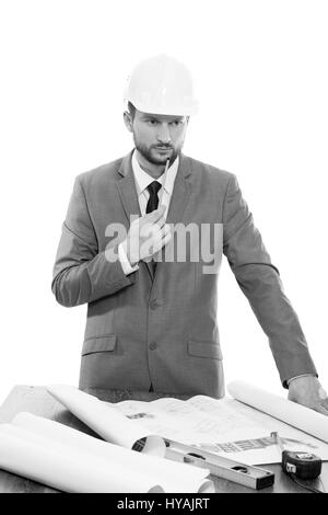 Mature male architect thinking while working on a blueprint Stock Photo