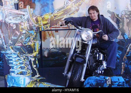 SACREMENTO, CALIFORNIA: Schwarzeneggar superfan Randy Jennings outside UNiversal Studios replica Terminator 2 Harley Davidson. THE WORLD’S number one Arnie superfan is celebrating his muscle-bound hero’s 67th birthday by revealing his Schwarzenegger shrine for the first time. From the carefully tending to his USD80K (£45K) collection of Arnold Schwarzenegger memorabilia to spending hours managing 90,000 new followers per month at his Arnie’s Army fansite – one superfan has made it his life’s mission to the Total Recall of his all-time idol. Since he was just eleven-years old and watched the le Stock Photo