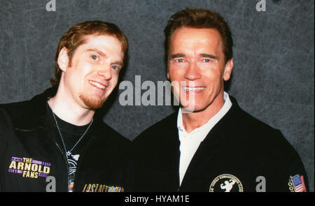 SACREMENTO, CALIFORNIA: Schwarzeneggar superfan Randy Jennings next to Arnie in 2003. THE WORLD’S number one Arnie superfan is celebrating his muscle-bound hero’s 67th birthday by revealing his Schwarzenegger shrine for the first time. From the carefully tending to his USD80K (£45K) collection of Arnold Schwarzenegger memorabilia to spending hours managing 90,000 new followers per month at his Arnie’s Army fansite – one superfan has made it his life’s mission to the Total Recall of his all-time idol. Since he was just eleven-years old and watched the legendary Arnie movie, Conan the Barbarian  Stock Photo