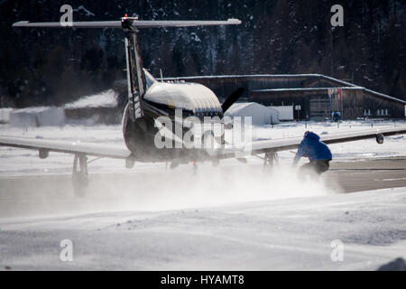 ENGADIN AIRPORT, SWITZERLAND: A BRITISH snowboarder reached speeds of 78 miles-per-hour and became the first person to snowboard while be towed by a commercial AEROPLANE. Daredevil Jamie Barrow (22) of the British Snowboard Cross Team is the UK’s fastest snowboarder and completed the incredible stunt by hanging from the wing of an aircraft Engadin Airport in Switzerland. Pictures show how Jamie skilfully snowboarded on the snowy edge of the runway, despite the frantic speed the aeroplane was travelling. Stock Photo