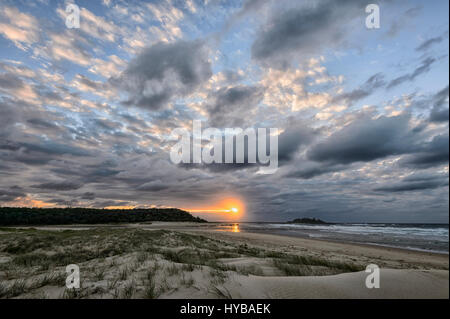 Atmospheric sky at sunrise over Conjola Beach, Shoalhaven, South Coast, New South Wales, NSW, Australia Stock Photo
