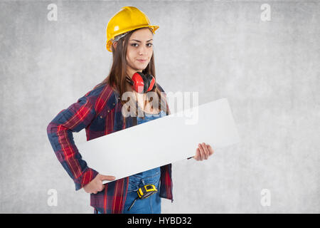 Serious female worker with advertising banner Stock Photo