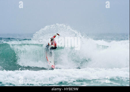 Surfer losing control and crashing into wave Stock Photo